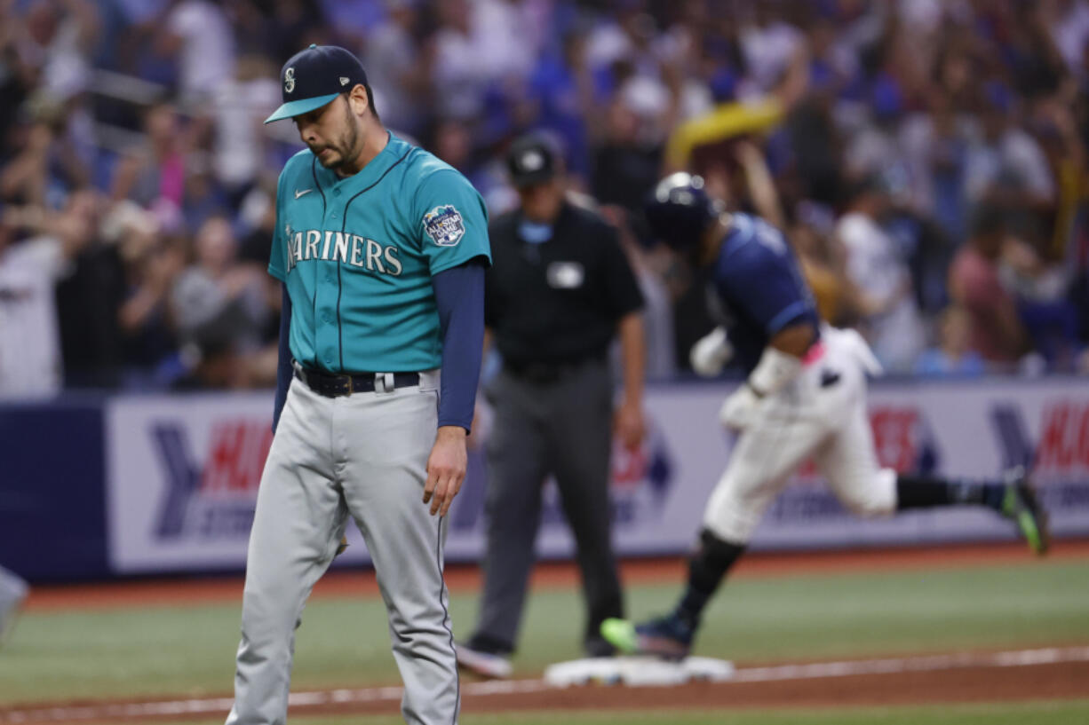 Seattle Mariners pitcher Tayler Saucedo stands on the field after giving up a game winning home run to the Tampa Bay Rays' Yandy Diaz, behind, during a baseball game Saturday, Sept. 9, 2023, in St. Petersburg, Fla.