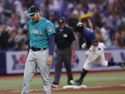 Seattle Mariners pitcher Tayler Saucedo stands on the field after giving up a game winning home run to the Tampa Bay Rays' Yandy Diaz, behind, during a baseball game Saturday, Sept. 9, 2023, in St. Petersburg, Fla.