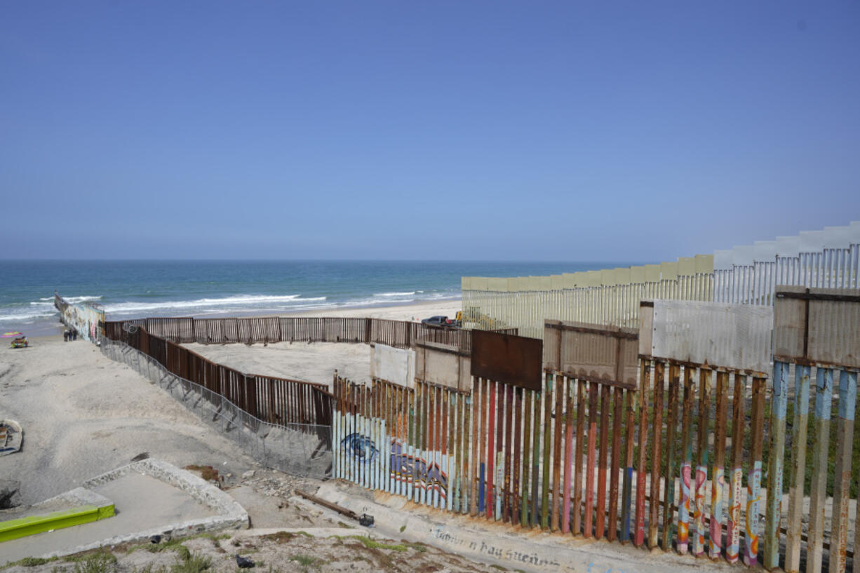 Construction continues on the border wall that separate the United States from Mexico, as seen from Tijuana, Mexico, Friday, Aug. 25, 2023. As the U.S. government built its latest stretch of border wall, Mexico made a statement of its own by laying remains of the Berlin Wall a few steps away.