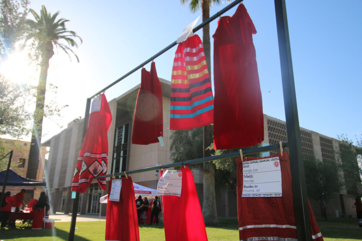 FILE - Red skirts are on display at the Arizona State Capitol in Phoenix, May 5, 2021, to raise awareness for missing and murdered Indigenous women and girls. The boyfriend of a Navajo woman whose case became emblematic of an international movement launched to draw attention to an epidemic of missing and murdered indigenous women was convicted of first-degree murder in her fatal shooting. Tre C. James, 31, was convicted Wednesday, Sept. 27, 2023 in U.S. District Court in Phoenix, in the domestic abuse and killing of his girlfriend Jamie Yazzie.