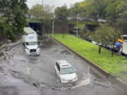 In this photo taken from video, traffic makes its way through flood waters along the Brooklyn Queens Expressway , Friday, Sept. 29, 2023, in New York. A potent rush-hour rainstorm has swamped the New York metropolitan area. The deluge Friday shut down swaths of the subway system, flooded some streets and highways, and cut off access to at least one terminal at LaGuardia Airport.