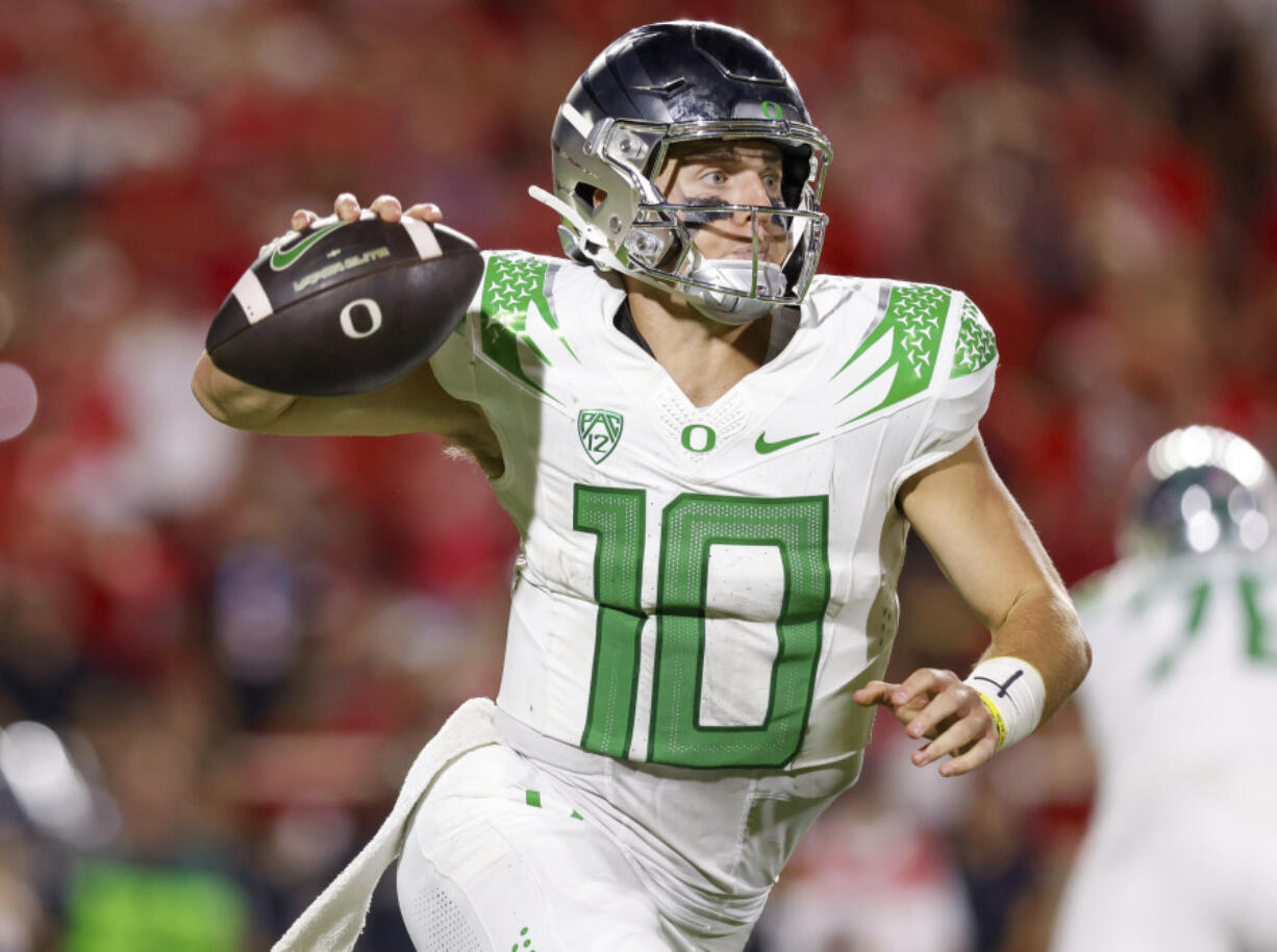 Oregon quarterback Bo Nix rolls out of the pocket against Texas Tech during the second half half of an NCAA college football game, Saturday, Sept. 9, 2023, in Lubbock, Texas.