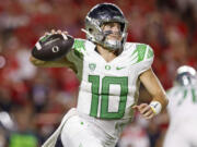 Oregon quarterback Bo Nix rolls out of the pocket against Texas Tech during the second half half of an NCAA college football game, Saturday, Sept. 9, 2023, in Lubbock, Texas.