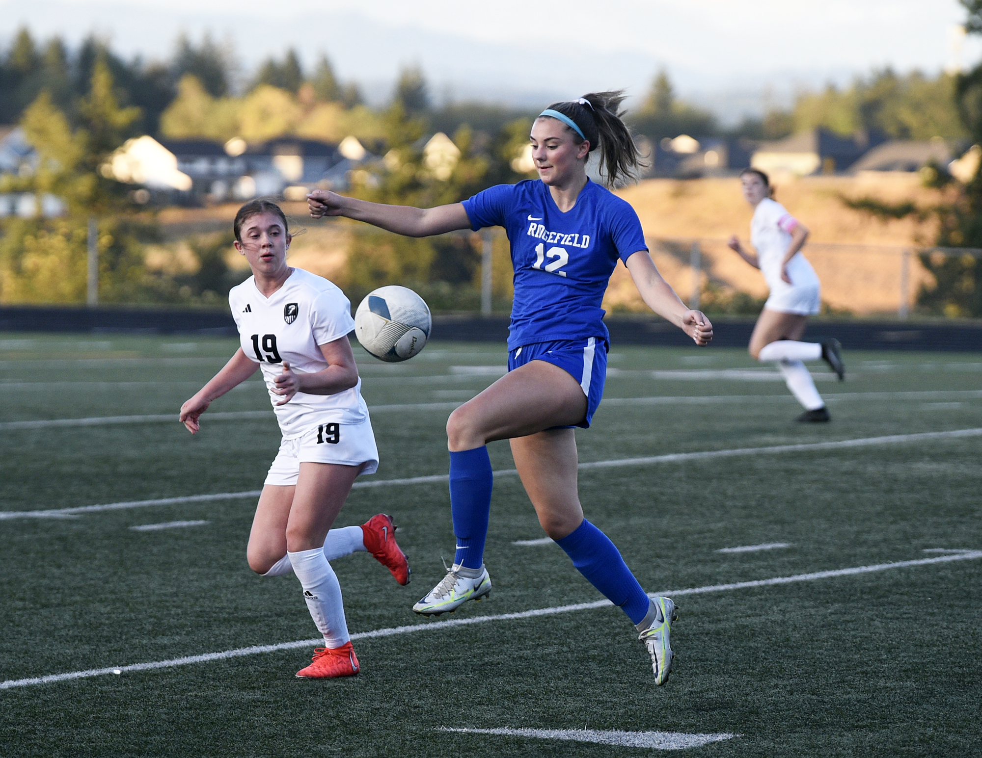 Ridgefield’s Marlee Buffham (12) controls the ball ahead of Union’s Sophia Euverman during a non-league girls soccer match at Ridgefield High School on Thursday, Sept. 7, 2023.