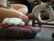 A doll and a model of the birthing canal is seen during a prenatal group meeting at The Farm Midwifery Center, Thursday, Aug. 31, 2023, in Summertown, Tenn. The Farm said fewer than 2% of clients end up having C-sections, and a report on deliveries in its first 40 years showed 5% of clients were transported to the hospital -- which midwife Corina Fitch said can happen because of things like water breaking early or exhaustion during labor. Clients usually give birth at The Farm or in their own homes.