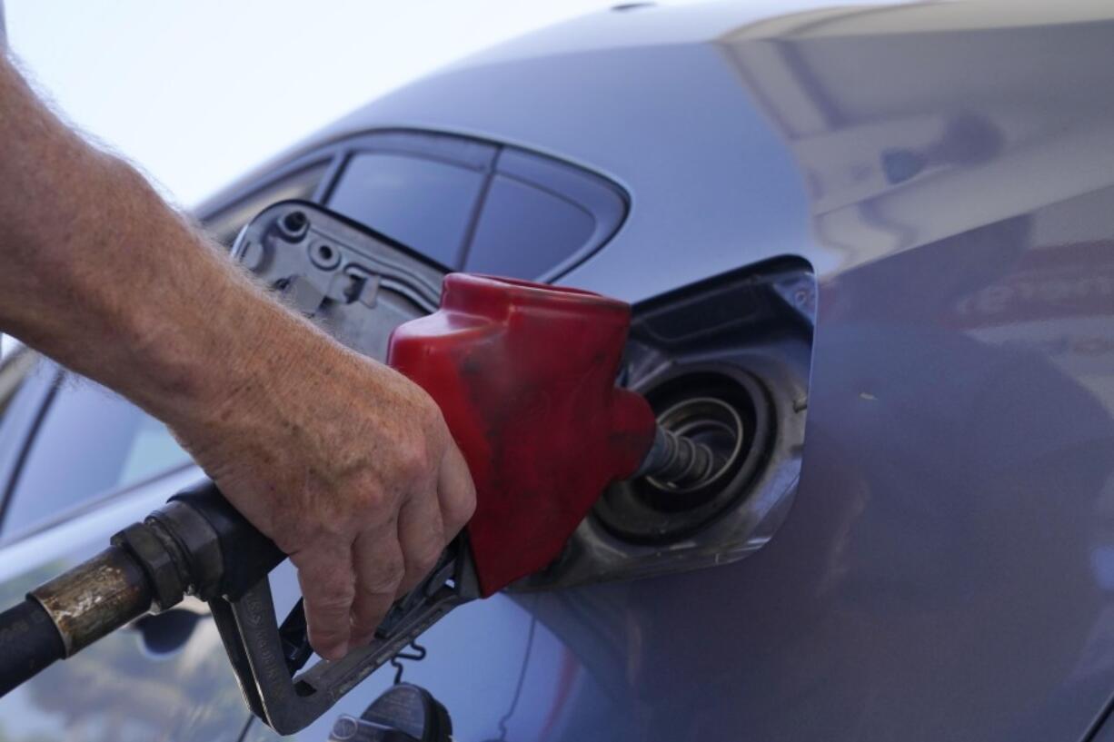 FILE - A customer pumps gas at an Exxon gas station, Tuesday, May 10, 2022, in Miami. Saudi Arabia and Russia agreed Tuesday, Sept. 5, 2023,  to extend their voluntary oil production cuts through the end of this year, trimming 1.3 million barrels of crude out of the global market and boosting energy prices. The dual announcements from Riyadh and Moscow pushed benchmark Brent crude above $90 a barrel in trading Tuesday afternoon, a price unseen in the market since last November.