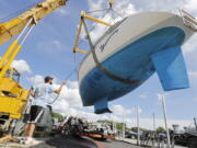 Davis & Tripp Marina and Boat Yard crews pull a sailboat named Hurricane from the waters of Padanaram Harbor in Dartmouth, Mass., Thursday, Sept. 14, 2023 in preparation for the possible arrival of Hurricane Lee.