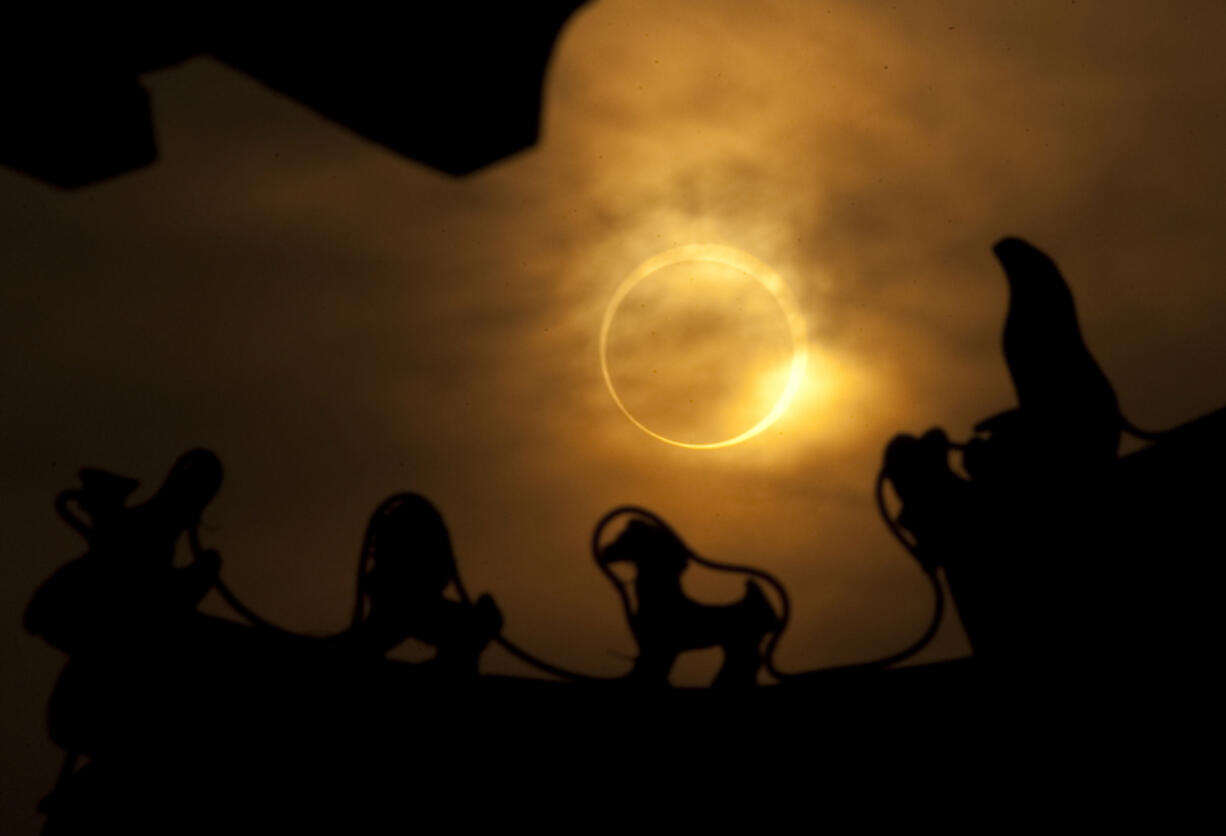 An annular or "ring of fire" eclipse is visible through the ceiling of an ancient building in Kaifeng, in central China's Henan province, on Jan. 15, 2010.