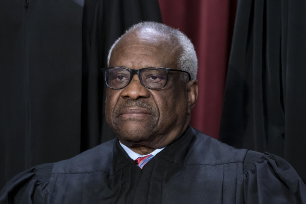 FILE - Associate Justice Clarence Thomas joins other members of the Supreme Court as they pose for a new group portrait, at the Supreme Court building in Washington, Oct. 7, 2022. Thomas is acknowledging that he took three trips last year aboard a private plane owned by Republican megadonor Harlan Crow. It's the first time in years that Thomas has reported receiving hospitality from Crow.  (AP Photo/J.