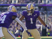 Washington wide receiver Rome Odunze (1) celebrates after his touchdown against Tulsa with teammate Germie Bernard (4) during the second half of an NCAA college football game Saturday, Sept. 9, 2023, in Seattle.