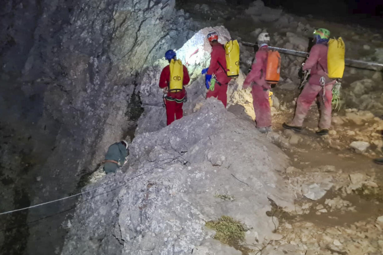 Members of the CNSAS, Italian alpine and speleological rescuers, start to descent on ropes the Morca cave during a rescue operation near Anamur, south Turkey, Monday, Sept. 11, 2023. A rescue operation is underway in Turkey's Taurus Mountains to bring out an American researcher who fell seriously ill at a depth of some 1,000 meters (3,000 feet) from the entrance of one of world's deepest caves last week and was unable to climb out himself. Mark Dickey is being assisted by international rescuers who by Monday had brought him up to 300 meters (nearly 1,000 feet).