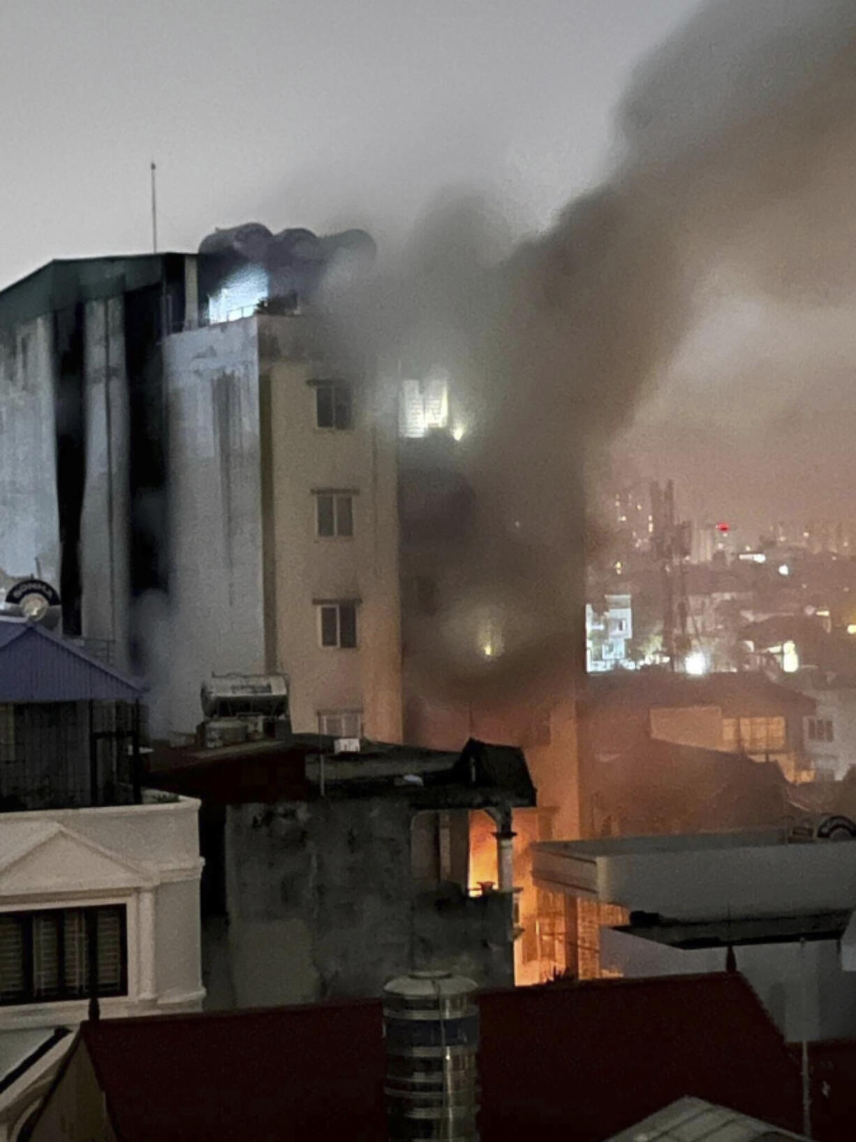 Smoke rises from a building in Hanoi, Vietnam Wednesday, Sept. 13, 2023. Authorities said "many" people had been killed after a fire broke out in the apartment block.