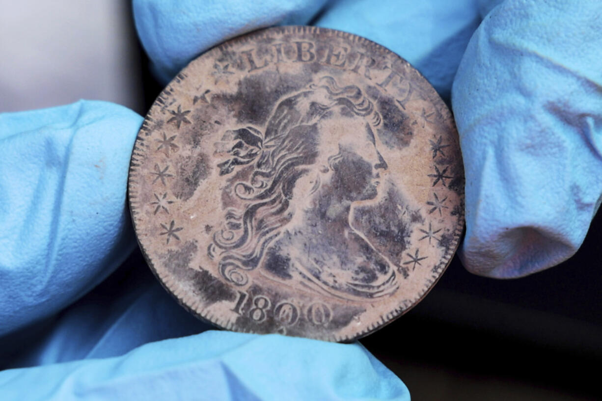 West Point archeologist Paul Hudson displays an 1800 Draped Bust Dollar found in a box in the base of a monument in West Point, N.Y. (U.S.