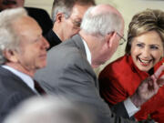 FILE - Democratic presidential hopeful Sen. Hillary Clinton, right, talks with Sen. Robert Bennett, R-Utah, second from left, as Sen. Joseph Lieberman, I-Conn., left, and Sen. Wayne Allard, R-Colo., obscured, looks on prior to President George W. Bush, not shown, spoke during the National Day of Prayer event, May 3, 2007, in the East Room of the White House in Washington.