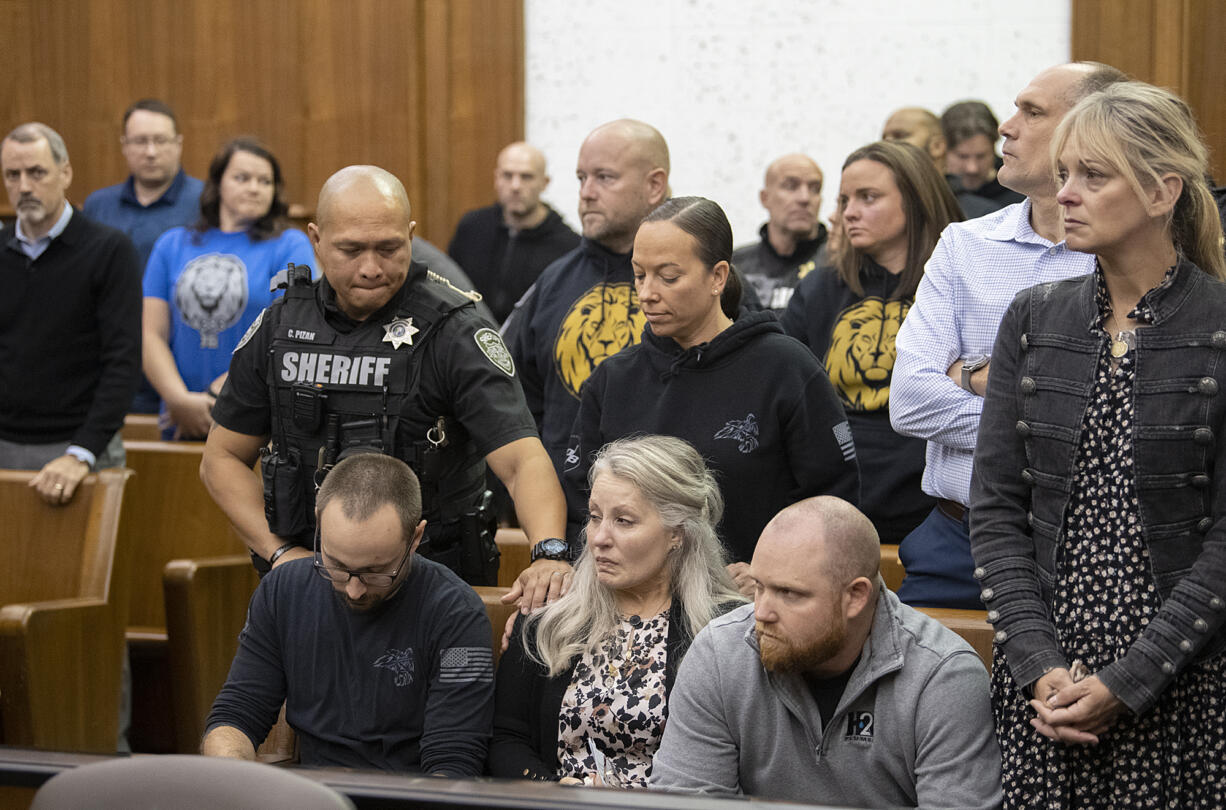 Friends, family and colleagues of Clark County sheriff's Sgt. Jeremy Brown look on as defendant Guillermo Raya Leon leaves the courtroom at the Clark County Courthouse on Thursday morning, Oct. 5, 2023, after being sentenced to life in prison following the 2021 fatal shooting of Brown.