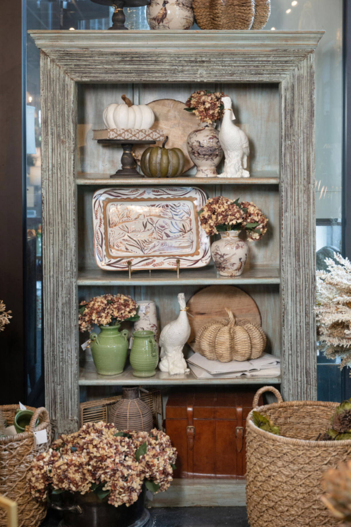 A French country-inspired bookcase takes center stage, offering a picturesque canvas for seasonal delights.