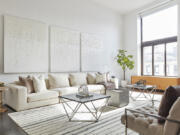 White-on-white artwork and white upholstery help make this living space feel modern and fresh.