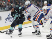 Seattle Kraken right wing Jordan Eberle (7) moves the puck as Edmonton Oilers defenseman Philip Broberg (86) defends during the third period of a preseason game last week. Eberle, an original Kraken, said he understands how last season -- disappointment aside -- helped establish the team.