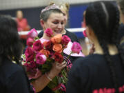 Alexis Mills, mother of La Center volleyball player Kylee Mills, is honored before La Center's Dig Pink match against Castle Rock on Tuesday at La Center High School.