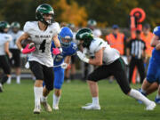 Woodland junior Elijah Andersen, left, runs with the ball on Sept. 7, 2023, during a game against La Center at La Center High School.