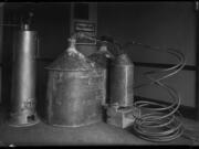 Law officers captured this illegal still in 1925. Rarely were such large stills placed inside buildings. Distilling alcohol poses the hazards of fire and explosion because the process releases flammable compounds. Outlaw distillers in Clark County, like Jesse Cousins, often hid stills on their rural farms.