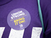 "Union strong, bring it on," reads the sticker on a member of Service Employees International Union  Local 49. Many family members of health care workers came out in solidarity.