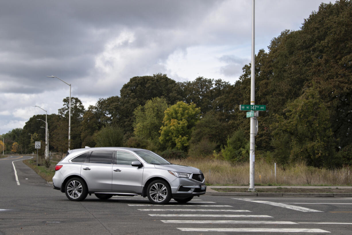 A motorist drives past the intersection of Northeast 147th Avenue and Northeast 59th Street, the site of a future warehouse. Under potential Vancouver ordinances discussed Monday night, warehouse developers would have to follow more stringent environmental guidelines.