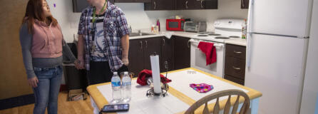 Katie Vongthongthip, left, and Chance Newbill talk in the kitchen in their new apartment.