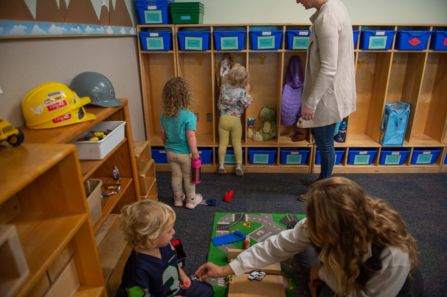 Walter Vizcaino, 2 1/2, plays with instructor Evelyn Polyakov, foreground, as other students put their things into their cubbies at WSU Vancouver's on-campus child care facility Oct. 4, 2023.