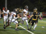 Eagles' Rafael Bauman, right, evades Panthers' defenders for a first down at Kiggins Bowl on Friday, Oct. 6, 2023.