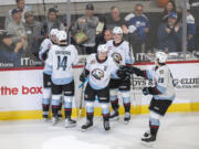 Winterhawks players celebrate with forward Kyle Chyzowski, third from left, after Chyzowski scored his third goal of the game Wednesday, Oct. 18, 2023, during the Winterhawks’ 11-1 win against the Brandon Wheat Kings at Veterans Memorial Coliseum in Portland.