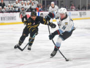 Portland Winterhawks forward Kyle Chyzowski, right, shoots the puck Wednesday, Oct. 18, 2023, during the Winterhawks’ 11-1 win against the Brandon Wheat Kings at Veterans Memorial Coliseum in Portland.