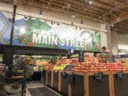 Shoppers browse for produce Wednesday during a grand opening celebration at the new downtown New Seasons market on Main Street.