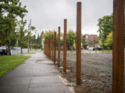 Fence posts stand in the ground Monday at the site of Vancouver's third Safe Stay community on West 11th Street.