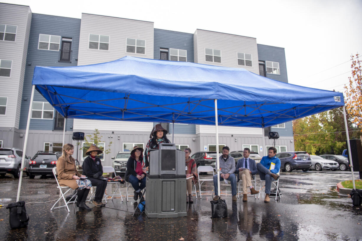 Cowlitz Tribal Council Member Suzanne Donaldson, center, delivers a land acknowledgment during the grand opening ceremony of the Nam'u qas apartment complex.