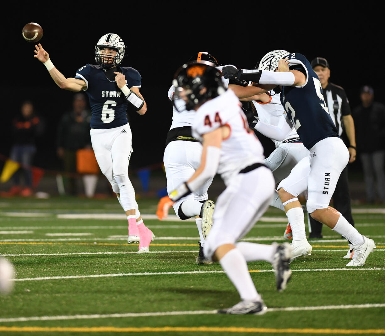 Skyview senior Jake Kennedy, left, passes the ball Friday, Oct. 20, 2023, during Skyview’s 49-10 win against Battle Ground at Kiggins Bowl.