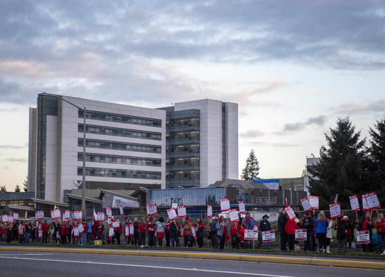 Health care workers on strike hold signs Monday, Oct. 23, 2023, at PeaceHealth Southwest Medical Center. Members of the Oregon Federation of Nurses and Health Professionals are striking for five days over low wages, low staffing levels and prolonged contract negotiations with PeaceHealth management.