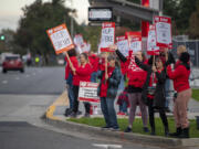 Health care workers on strike hold signs Monday, Oct. 23, 2023, at PeaceHealth Southwest Medical Center. Members of the Oregon Federation of Nurses and Health Professionals are striking for five days over low wages, low staffing levels and prolonged contract negotiations with PeaceHealth management.