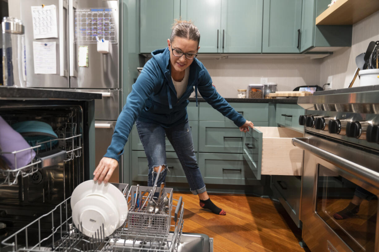 Twin Cities Instagrammer/organizing expert/author Jessica Litman always empties the dishwasher first thing in the morning Sept. 26, in her home in Maple Grove, Minn.