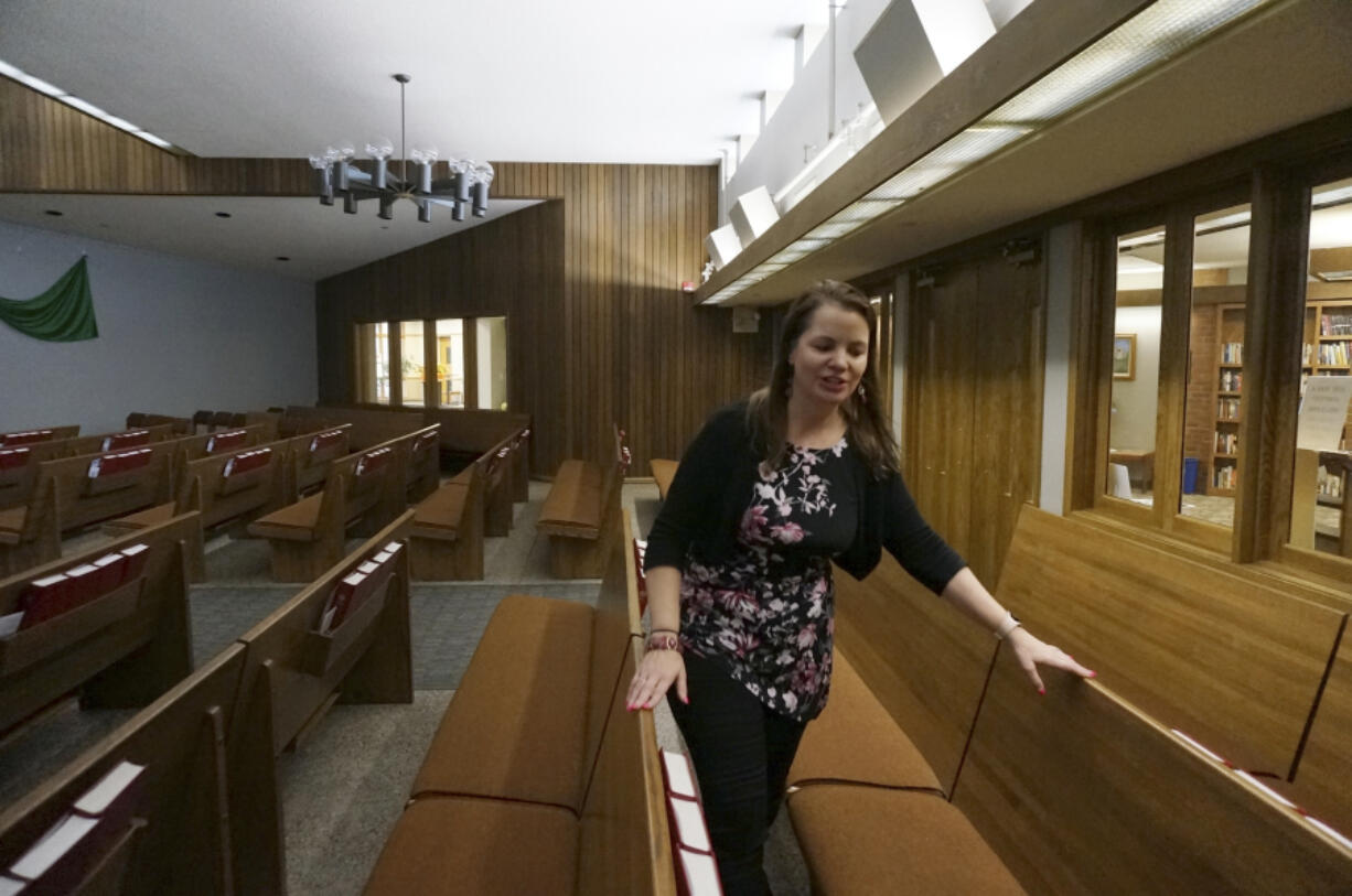 The Rev. Karna Moskalik walks through each line of pews in the sanctuary of Our Savior's Lutheran Church on Sept. 27 in Stillwater, Minn.