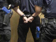 Officers in training handcuff a suspect in a mock exercise at the Criminal Justice Training Academy in Burien, Washington, Tuesday, Sept. 19, 2023. Guns in the holsters are fake, made of plastic. (Ellen M.