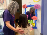 Nurse Jodi Bobbitt helps a youngster at William Ramsay Elementary in Alexandria, Va.