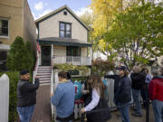 Visitors line up to enter the birthplace of Walt Disney at the corner of North Tripp Avenue and West Palmer Street in Chicago's Hermosa neighborhood.