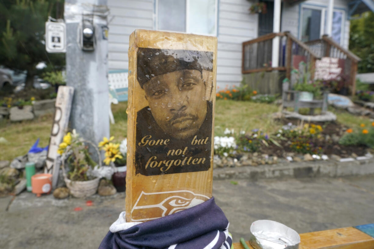 A sign is displayed on May 27, 2021, at a memorial in Tacoma where Manuel Ellis died on March 3, 2020, after he was restrained by police officers.