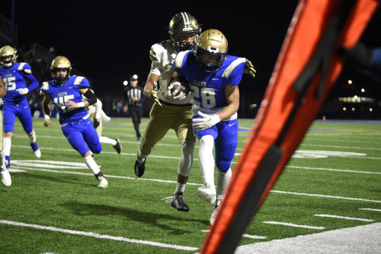 Kelso’s Aden Mintonye (28) is driven out of bounds near the first-down marker by Evergreen’s Josiah Alanis during a 3A GSHL football game on Friday, Oct. 27, 2023, at Kelso High School.