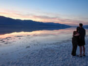 British visitors Todd Robertson and Karina Shah at Badwater Basin in California's Death Valley National Park, on Oct. 16, 2023.