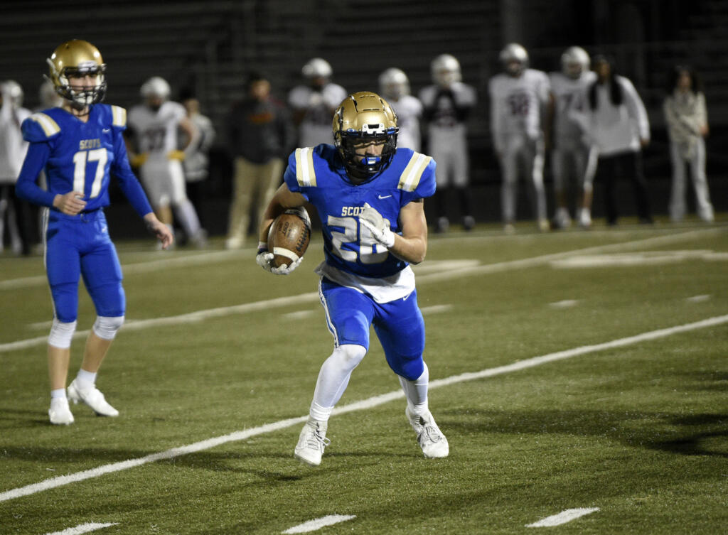 Kelso running back Aden Mintonye rushes upfield against Prairie during a 3A Greater St. Helens League tiebreaker at Doc Harris Stadium in Camas on Monday, Oct. 30, 2023.