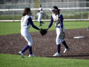 Columbia River shortstop Mia Yanez (21) is congratulated by outfield Sydney Seibert-Wilder (9) after Yanez made a diving play in the infield against Evergreen in the 3A/2A slowpitch softball district tournament at Heritage High School on Friday, Oct. 20, 2023.