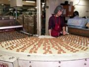 Almond Roca heads around a bend on the conveyor belt into the chocolate coating machine at candymaker Brown and Haley's Tacoma Wash. plant on Monday, June 12, 2000. J.C. Haley teamed up with candymaker and store owner  Harry L. Brown to start the company in 1914.