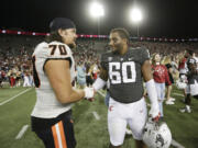 Oregon State offensive lineman Jake Levengood (70) and Washington State defensive tackle David Gusta (60) greet each other after an NCAA college football game, Saturday, Sept. 23, 2023, in Pullman, Wash.